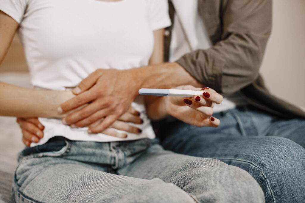 excited couple holding positive pregnancy test at 2026 03 16 02 11 42 utc